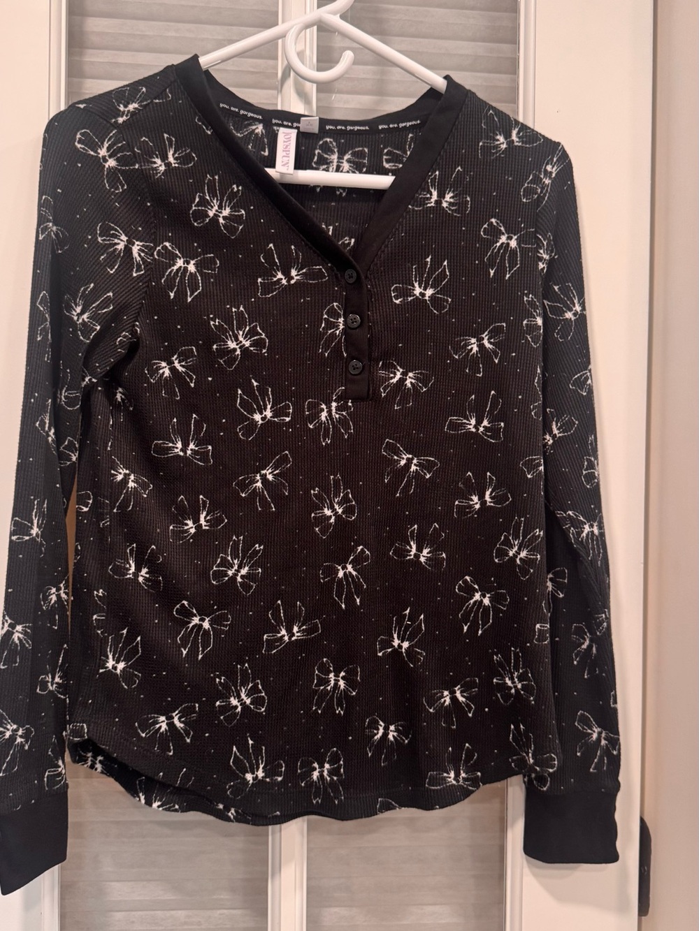 Long-Sleeve Black Henley Top with White Bow Print
